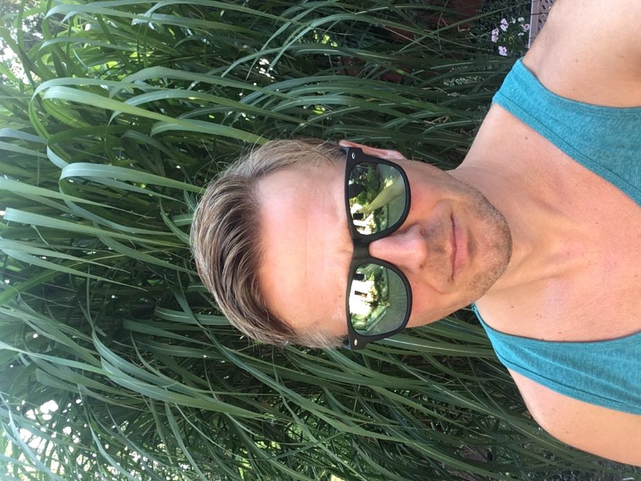 Awesome handsome blond man in sunglasses. In the background a reed 